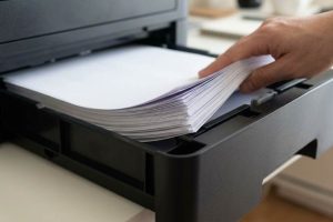 Cleaning printer feed rollers to prevent paper misfeeds