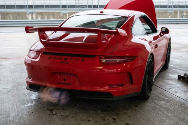 Mechanic diagnosing rough idle in a performance track car