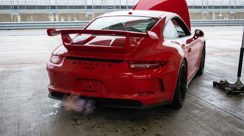 Mechanic diagnosing rough idle in a performance track car
