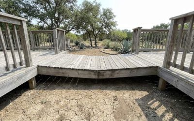 Inspecting sagging wooden deck framing in Austin TX